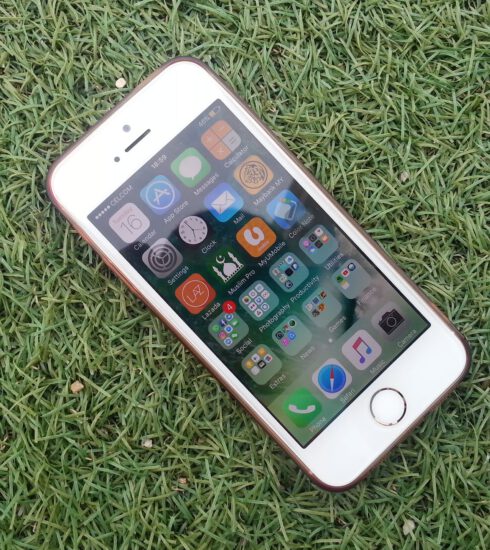 silver iphone on a green grass